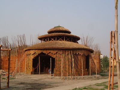 The round bamboo Harmony Center surrounded by scaffolding