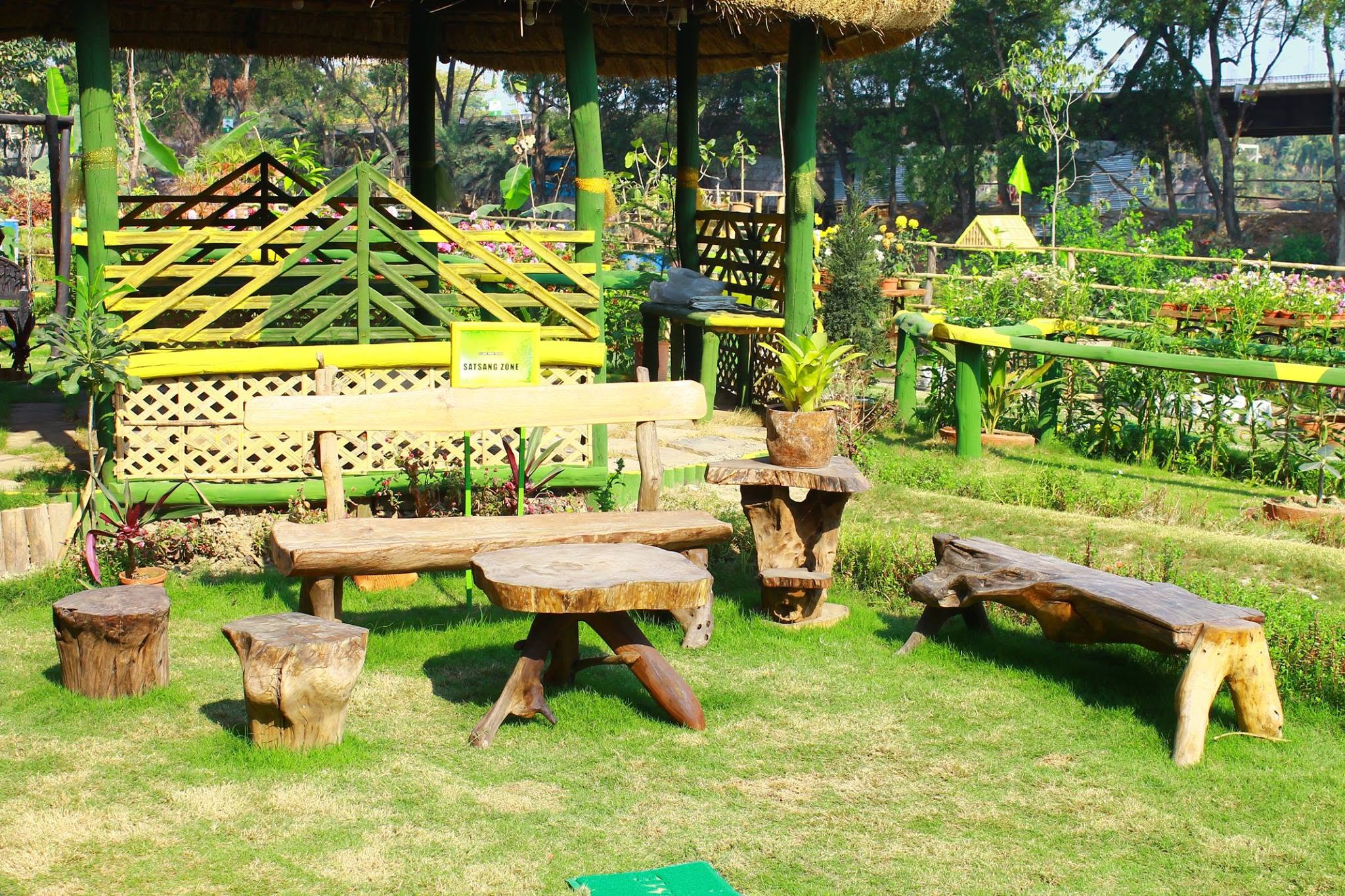 River-wood benches and stump stools in the Satsang Zone