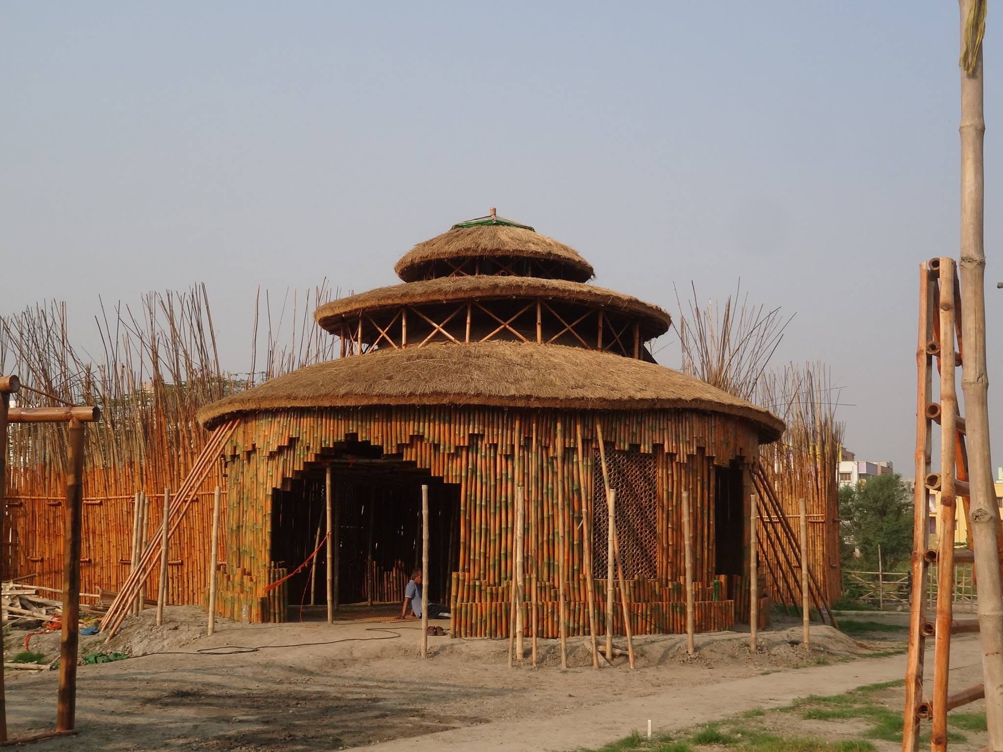 Three-tiered thatched bamboo pavilion under construction